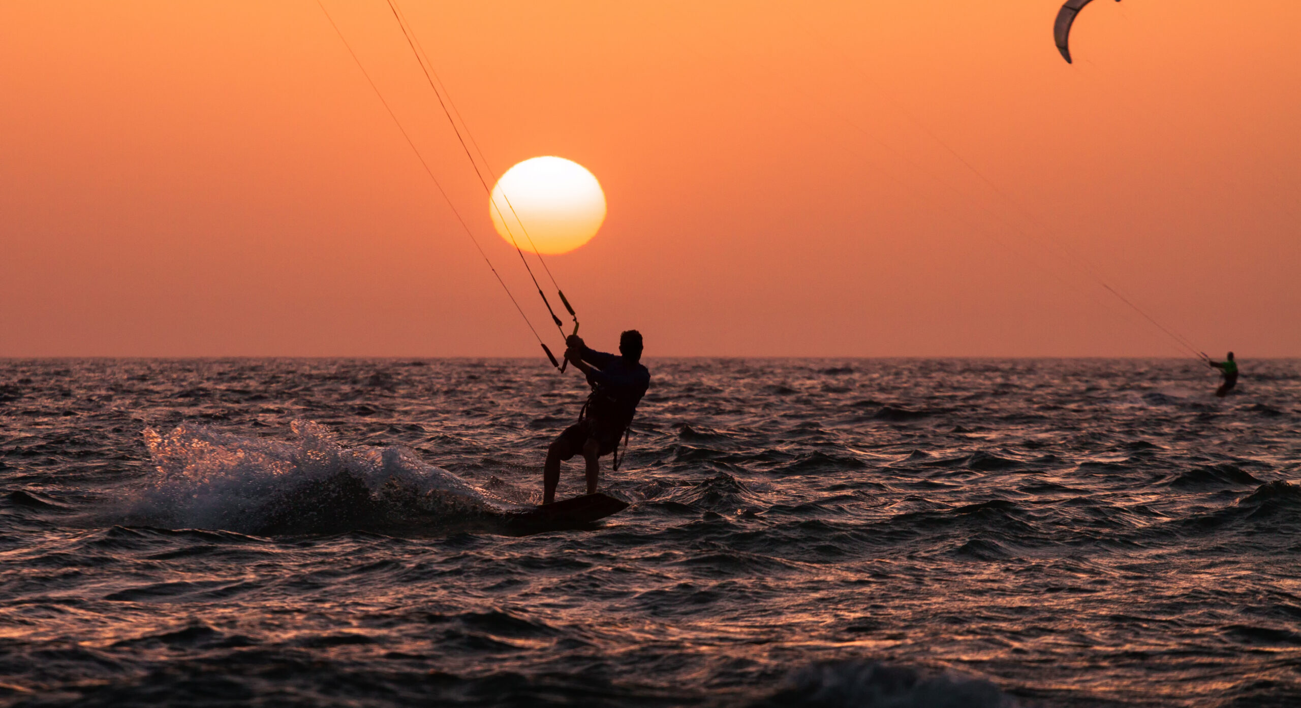 People ride a Kiteboarding during the sunset. Mediterranean sea, Israel